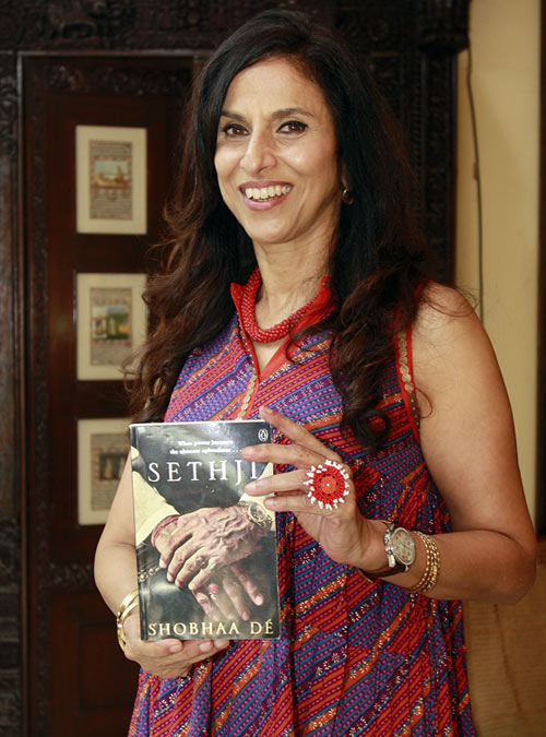 Shobhaa De holds up a copy of her latest book, Sethji