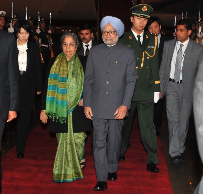 Dr Singh and his wife Gursharan Kaur arrive at the Beijing International Airport in China on Tuesday.
