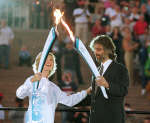 Olivia Newton-John and Italian tenor Andrea Bocelli carry the Olympic torches at the Sydney Opera House