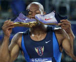 Greene kisses his shoes after crossing the finish line. REUTERS/Jerry Lampen 