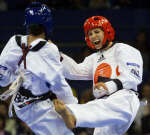 Lauren Burns (R) kicks Cuban Urbia Melendez Rodriguez during their under 49kg final. REUTERS/Kimimasa Mayama 