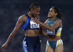 Cathy Freeman (R) congratulates Marion Jones after the 200m final. REUTERS/Gary Hershorn 