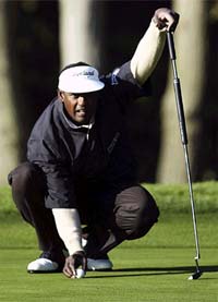 Vijay Singh lines up a putt