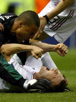 Andriy Shevchenko celebrates with Brazilian goalkeeper Dida after scoring the winning goal