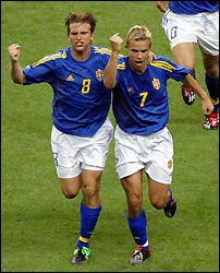 Sweden's Niclas Alexandersson (R) celebrates with team mate Anders Svensson after scoring.