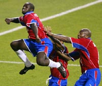 Costa Rica's Winston Parks (L) celebrates his goal against Turkey with team mates Paulo Wanchope (R) and Walter Centeno. 