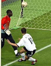 Miroslav Klose heads past Cameroon's goalkeeper Boukar Alioum. 