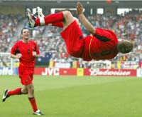 Belgium's Wesley Sonck flips in celebration after scoring against Russia while his team mate Bart Goor watches.