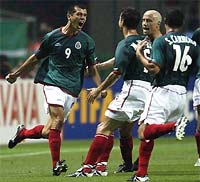 Mexico players rejoice after beating Croatia in their first match.