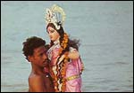 Devi Durga is borne into the river